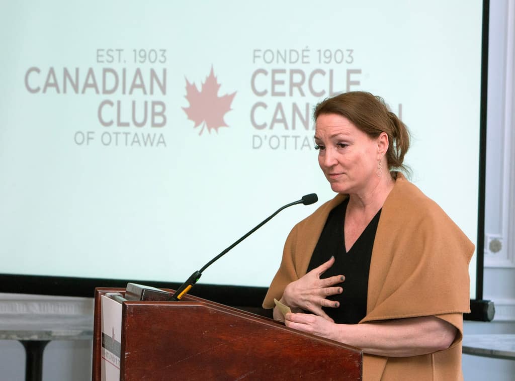 A Board director addresses guests from the Club podium