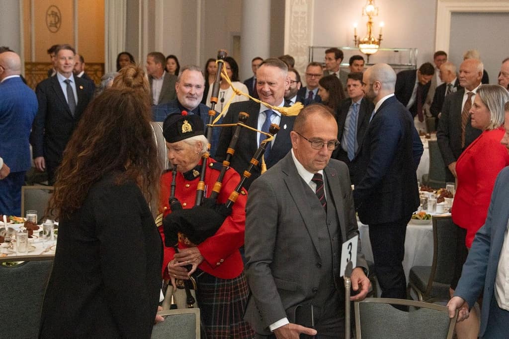 RCMP pipers lead the head table through the room at the 2026–2027 season opener